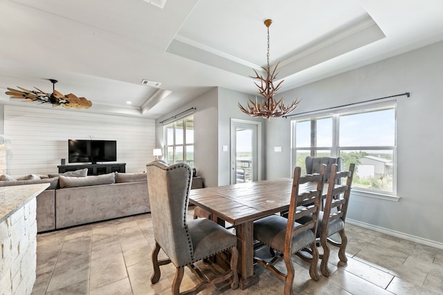 192 Primrose Path, Canyon Lake, TX 78133 - dining area featuring a tray ceiling, a chandelier, ornamental molding, and baseboards