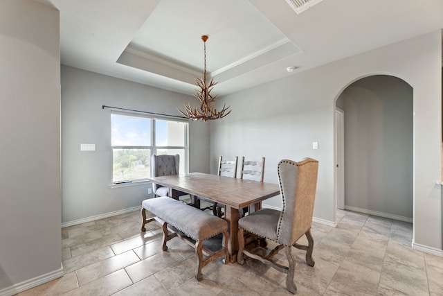 192 Primrose Path, Canyon Lake, TX 78133 - dining area with a chandelier, arched walkways, baseboards, a tray ceiling, and crown molding