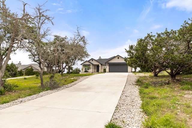 192 Primrose Path, Canyon Lake, TX 78133 - view of front of house featuring driveway, an attached garage, and stucco siding