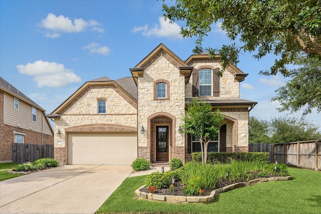 19427 Stanton Lake Dr, Cypress, TX 77433 - french country style house with stone siding, concrete driveway, and brick siding