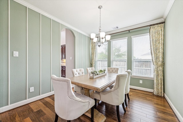 19427 Stanton Lake Dr, Cypress, TX 77433 - dining space with a chandelier, arched walkways, crown molding, dark wood-style floors, and baseboards