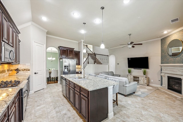 19427 Stanton Lake Dr, Cypress, TX 77433 - kitchen featuring a sink, appliances with stainless steel finishes, crown molding, ceiling fan, and open floor plan