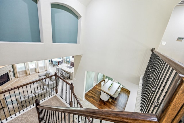 19427 Stanton Lake Dr, Cypress, TX 77433 - stairway featuring a high ceiling, a glass covered fireplace, and baseboards
