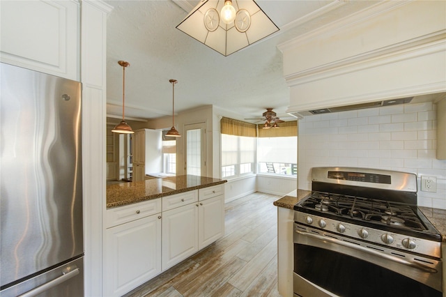 22211 Bucktrout Ln, Katy, TX 77449 - kitchen featuring appliances with stainless steel finishes, backsplash, light wood-type flooring, white cabinets, and dark stone counters