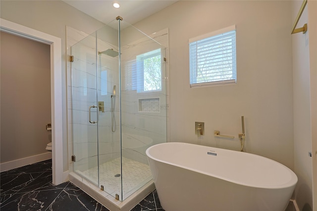 full bath with marble tiled flooring, a stall shower, a freestanding bath, baseboards, and recessed lighting