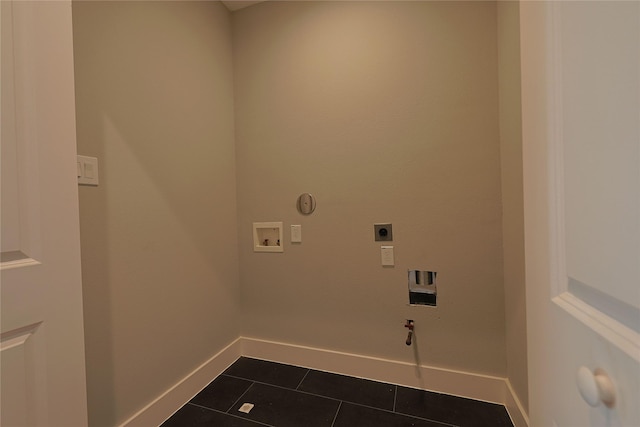 clothes washing area featuring gas dryer hookup, dark tile patterned flooring, washer hookup, baseboards, and hookup for an electric dryer