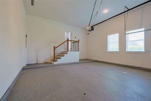 unfurnished living room with baseboards and stairway