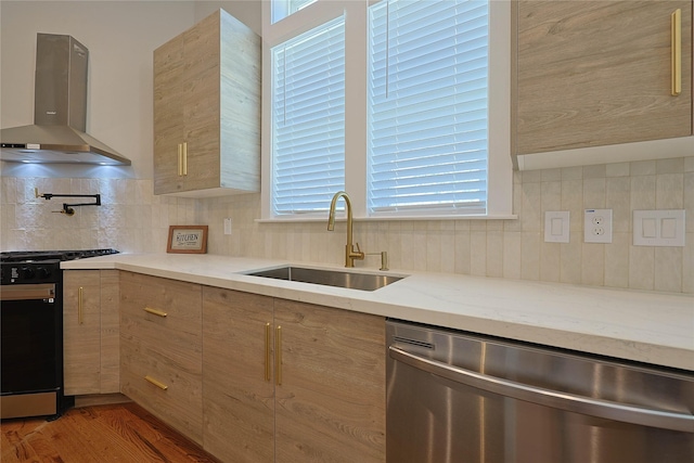 kitchen featuring dishwasher, gas range oven, ventilation hood, a sink, and modern cabinets