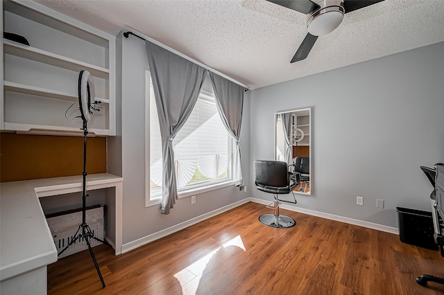 2215 Braesmeadow Ln, Sugar Land, TX 77479 - miscellaneous room featuring ceiling fan, a textured ceiling, wood finished floors, an office area, and baseboards