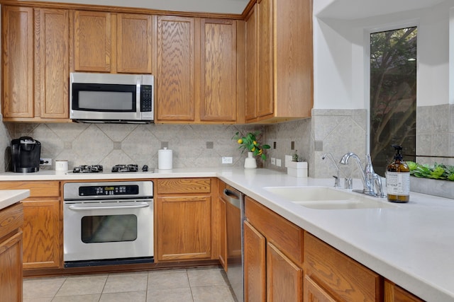 2331 Fern Bend Ln, Katy, TX 77494 - kitchen with appliances with stainless steel finishes, a sink, light countertops, and decorative backsplash