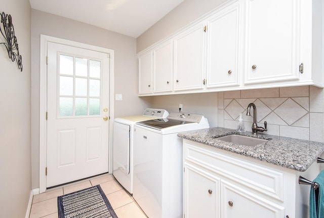 13602 Wendelyn Ln, Houston, TX 77069 - laundry room featuring washing machine and clothes dryer, cabinet space, light tile patterned flooring, and baseboards