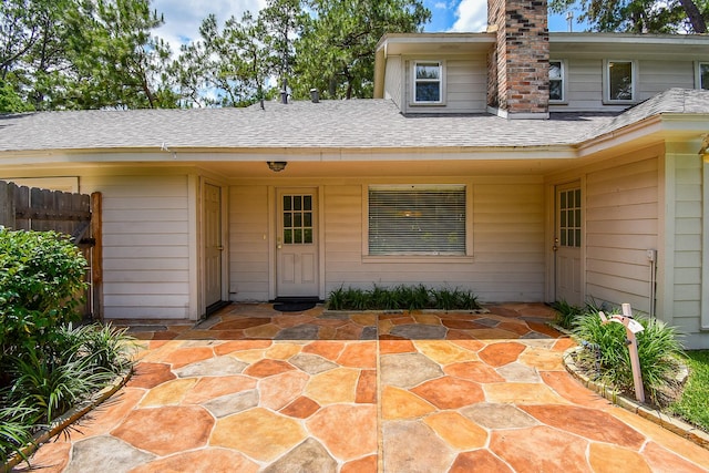 13602 Wendelyn Ln, Houston, TX 77069 - entrance to property featuring fence, roof with shingles, a chimney, and a patio area