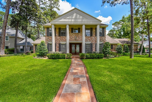 13602 Wendelyn Ln, Houston, TX 77069 - neoclassical / greek revival house with french doors, brick siding, and a front lawn
