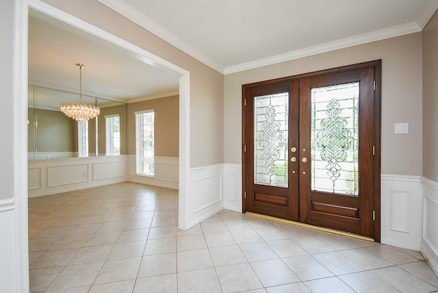 13602 Wendelyn Ln, Houston, TX 77069 - entrance foyer with french doors, a chandelier, a decorative wall, ornamental molding, and wainscoting