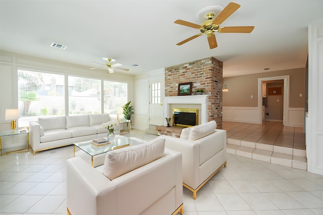 13602 Wendelyn Ln, Houston, TX 77069 - living room with ceiling fan, a decorative wall, light tile patterned floors, wainscoting, and a fireplace