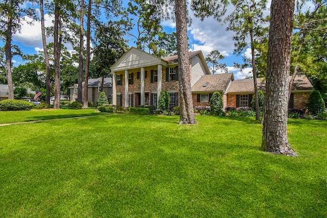 13602 Wendelyn Ln, Houston, TX 77069 - neoclassical / greek revival house featuring brick siding, a front lawn, and roof with shingles