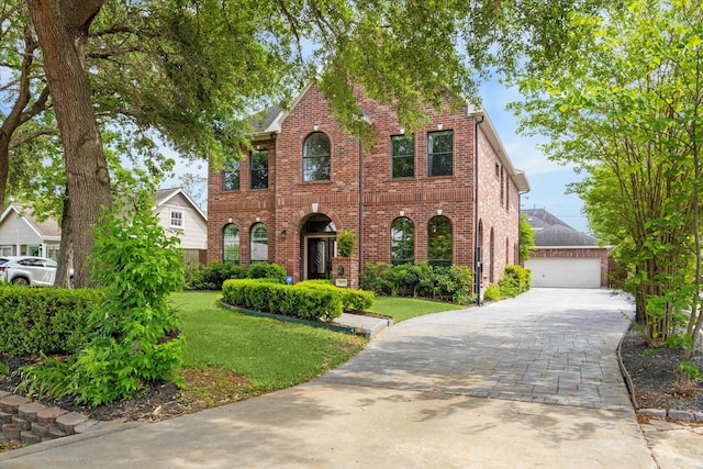 1015 W 41st St, Houston, TX 77018 - view of front of home featuring brick siding, a front lawn, a garage, and an outbuilding