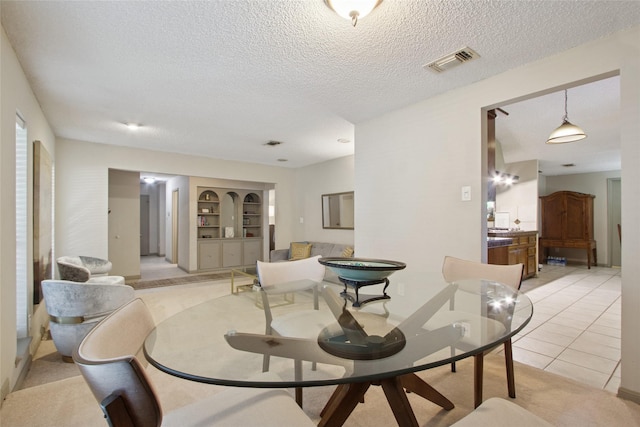 1110 Cheshire Ln, Houston, TX 77018 - dining space featuring a textured ceiling, built in features, and light tile patterned flooring
