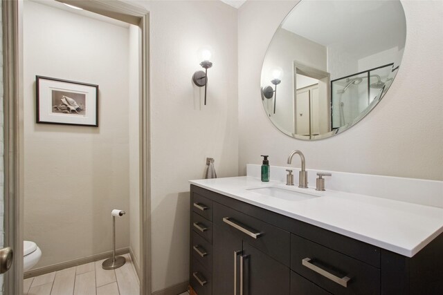 1110 Cheshire Ln, Houston, TX 77018 - bathroom with toilet, vanity, and baseboards