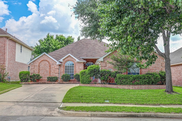 5316 Lake Mead Trl, Fort Worth, TX 76137 - view of front of home with brick siding, a front yard, roof with shingles, and concrete driveway