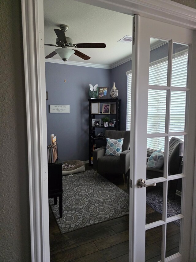 sitting room featuring ornamental molding, ceiling fan, and wood finished floors