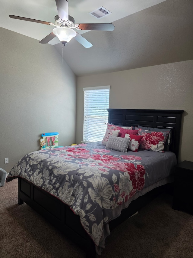 bedroom featuring carpet floors, vaulted ceiling, and a ceiling fan
