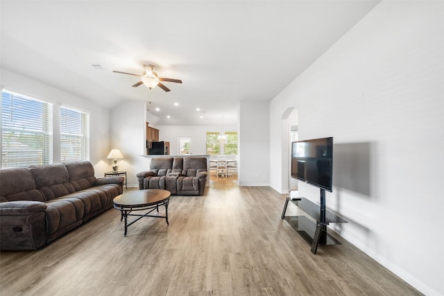 6186 White Oak Leaf Loop, Conroe, TX 77303 - living area featuring light wood-style floors, a ceiling fan, arched walkways, baseboards, and vaulted ceiling