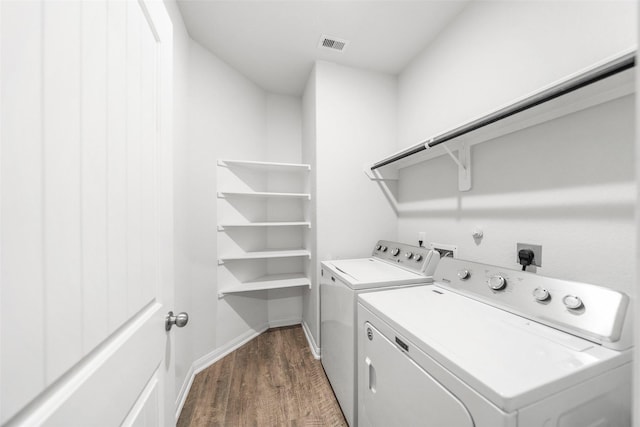 6186 White Oak Leaf Loop, Conroe, TX 77303 - laundry room featuring washer and clothes dryer, dark wood-type flooring, and baseboards