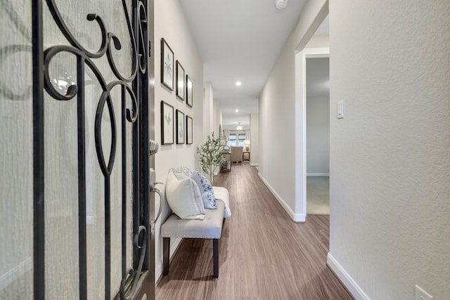 21310 Baldovin Way, Tomball, TX 77375 - corridor with wood finished floors, baseboards, a textured wall, and recessed lighting