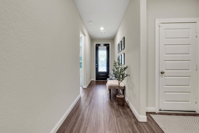 21310 Baldovin Way, Tomball, TX 77375 - doorway featuring dark wood finished floors, baseboards, a textured wall, and recessed lighting