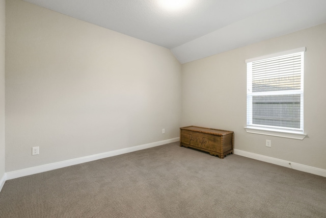21310 Baldovin Way, Tomball, TX 77375 - carpeted empty room featuring lofted ceiling and baseboards