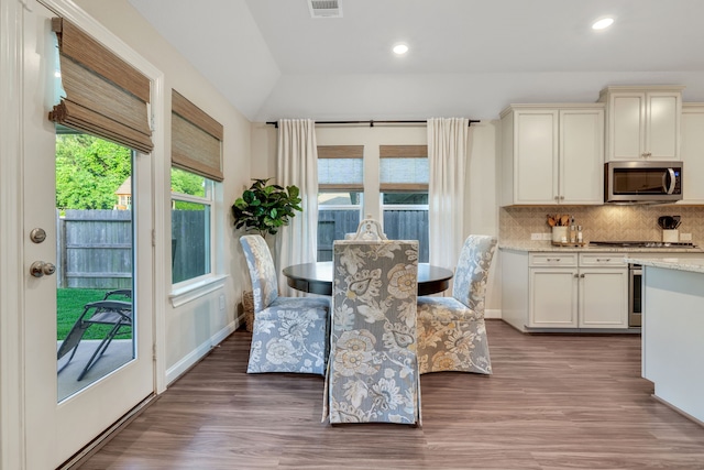 21310 Baldovin Way, Tomball, TX 77375 - dining area featuring wood finished floors, vaulted ceiling, recessed lighting, and baseboards