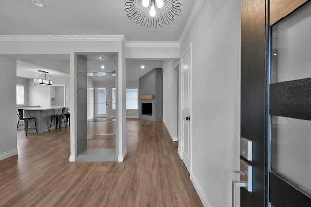 2806 Triway Ln, Houston, TX 77043 - foyer with ornamental molding, a chandelier, wood finished floors, baseboards, and a fireplace