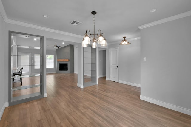 2806 Triway Ln, Houston, TX 77043 - unfurnished living room featuring crown molding, baseboards, wood finished floors, a fireplace, and a chandelier