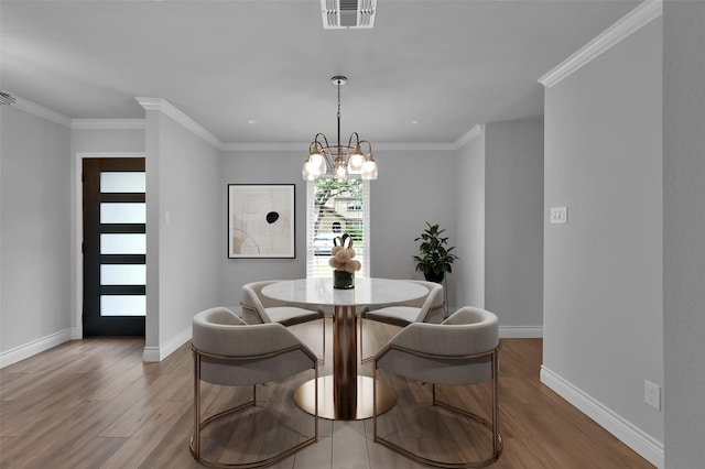 2806 Triway Ln, Houston, TX 77043 - dining area featuring wood finished floors, a chandelier, baseboards, and crown molding