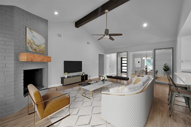2806 Triway Ln, Houston, TX 77043 - living area featuring wood finished floors, beam ceiling, high vaulted ceiling, a ceiling fan, and a fireplace