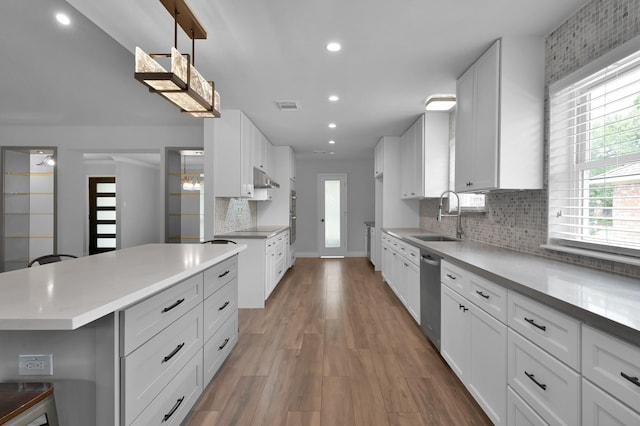 2806 Triway Ln, Houston, TX 77043 - kitchen featuring a sink, stainless steel dishwasher, white cabinetry, decorative backsplash, and recessed lighting