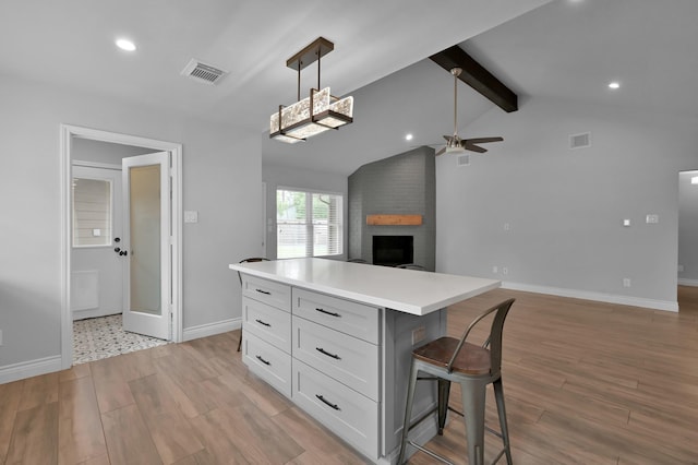 2806 Triway Ln, Houston, TX 77043 - kitchen with ceiling fan, a kitchen bar, white cabinetry, light wood finished floors, and recessed lighting