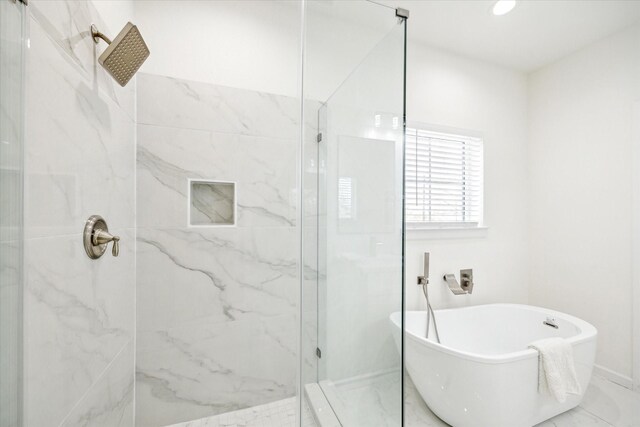 927 Bianco Ln, Houston, TX 77091 - bathroom with a marble finish shower and a freestanding tub
