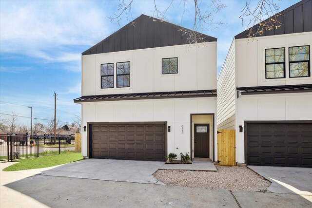 927 Bianco Ln, Houston, TX 77091 - view of front of property featuring a standing seam roof, fence, a garage, concrete driveway, and metal roof