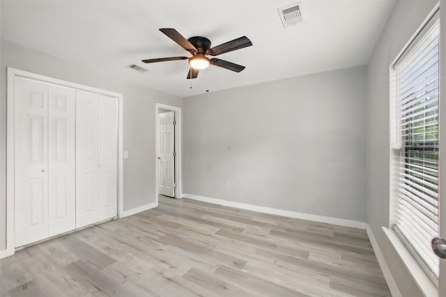 3221 Texas Ave, Texas City, TX 77590 - unfurnished bedroom with light wood-style floors, a closet, and ceiling fan