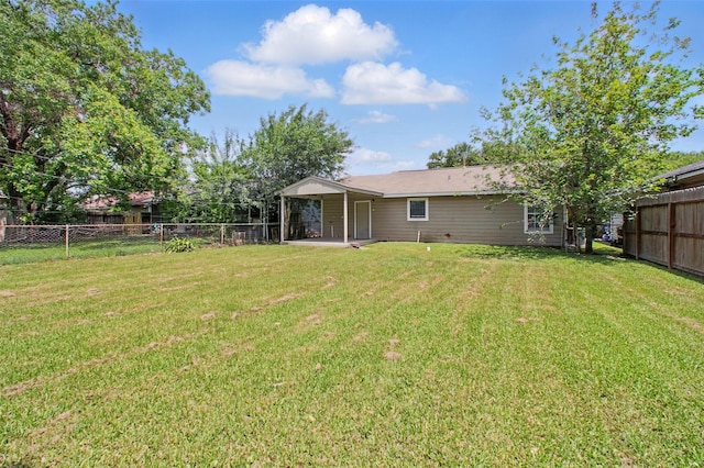 3221 Texas Ave, Texas City, TX 77590 - rear view of house with a fenced backyard and a patio area
