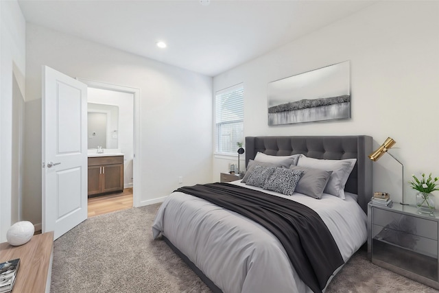 1013 Erin St Unit R, Houston, TX 77009 - bedroom with light colored carpet, ensuite bath, a sink, recessed lighting, and baseboards