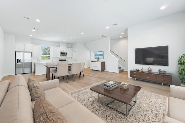 1013 Erin St Unit R, Houston, TX 77009 - living area with stairway, light wood-style flooring, recessed lighting, and baseboards