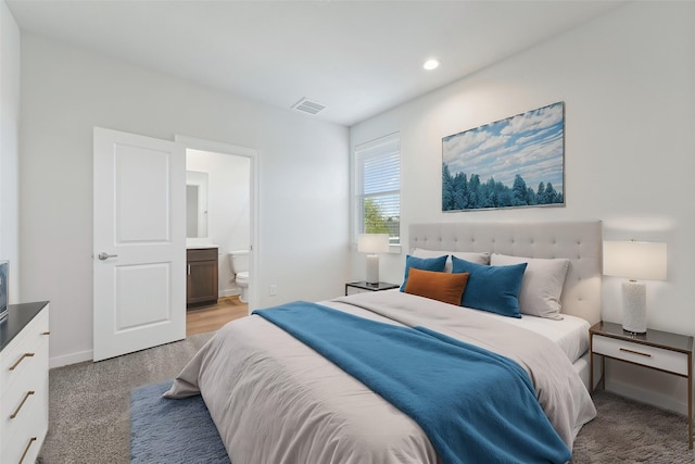 1013 Erin St Unit R, Houston, TX 77009 - bedroom with light carpet, ensuite bathroom, recessed lighting, and baseboards