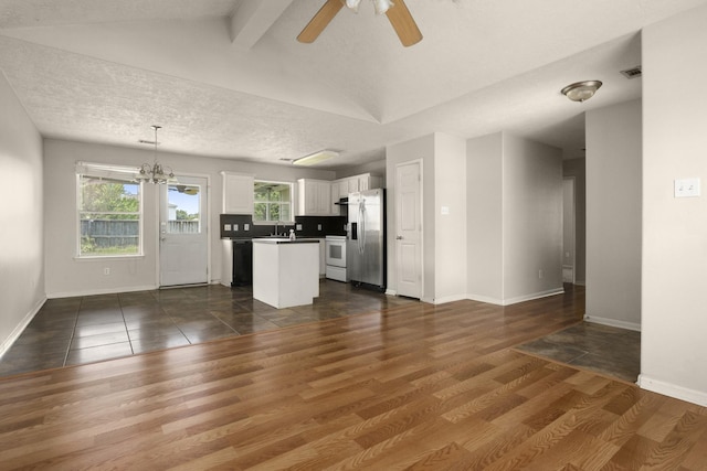 kitchen featuring stainless steel fridge, plenty of natural light, ceiling fan, white cabinetry, and a textured ceiling