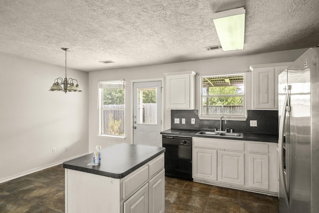 kitchen featuring stainless steel fridge with ice dispenser, a sink, dishwasher, dark countertops, and plenty of natural light