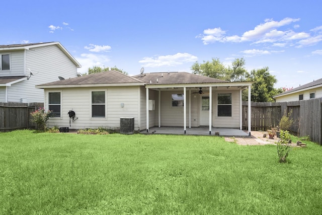 rear view of house featuring a ceiling fan, a patio area, and roof with shingles