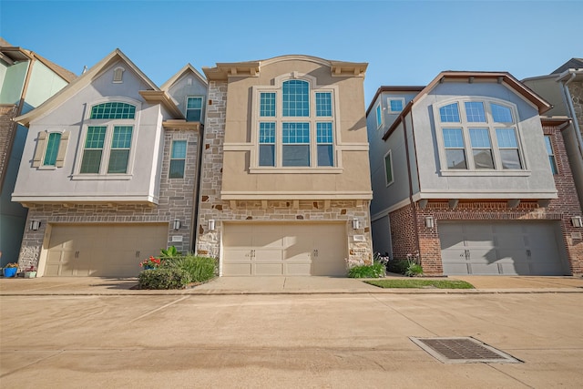 11007 Acorn Falls Dr, Houston, TX 77043 - view of property with a garage, driveway, stone siding, and stucco siding
