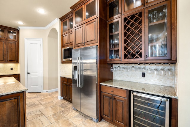 kitchen with stainless steel appliances, beverage cooler, crown molding, decorative backsplash, and baseboards